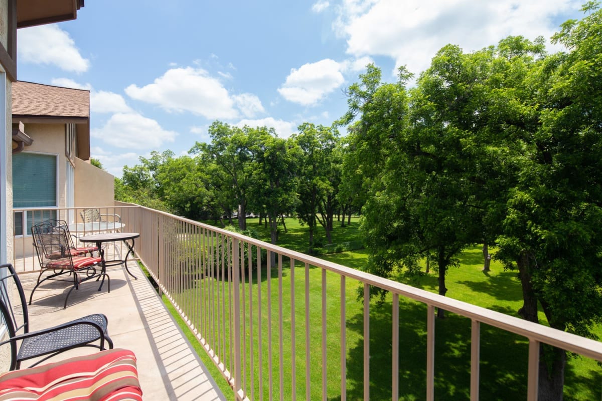 Waterwheel condo balcony with furniture.