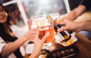 Close up of group toasting drinks.