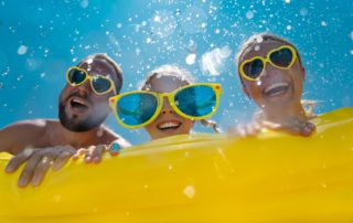 A family of three are enjoying a tubing ride at one of the 2 New Braunfels waterparks.