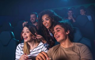 Three friends in a New Braunfels Movie Theater.