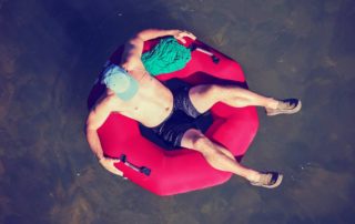 A man tubing in Comal River.